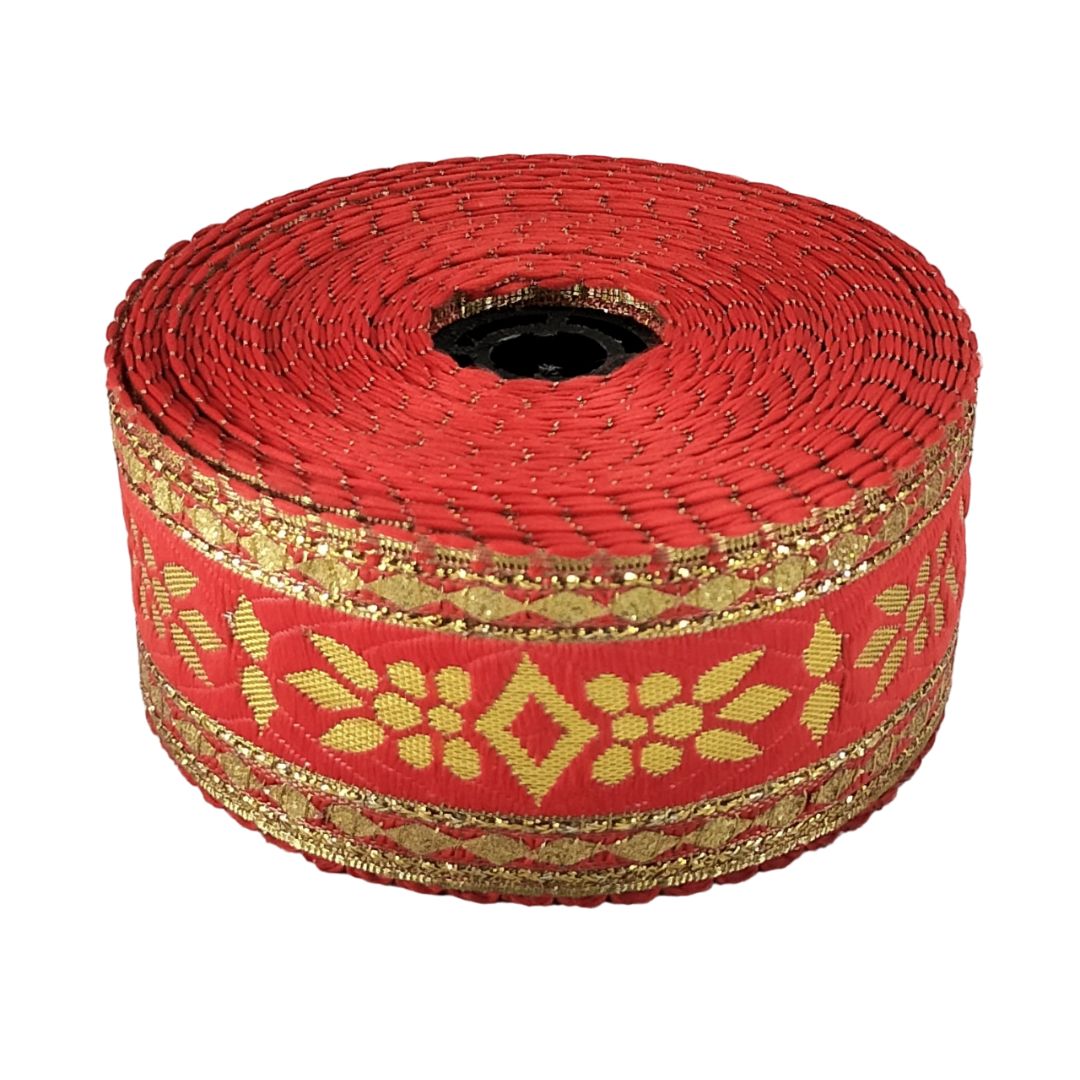 Roll of red ribbon with gold patterns on a white background