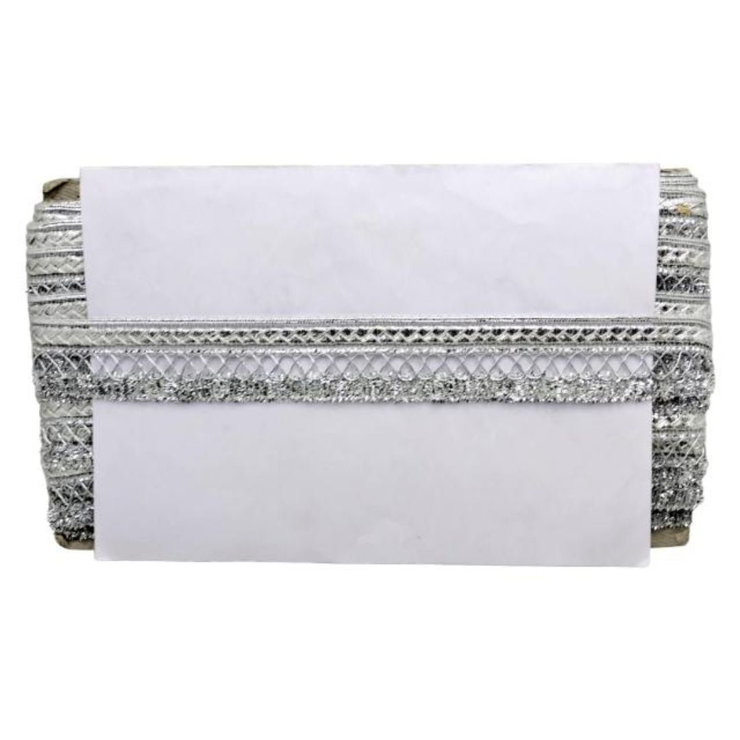 White clutch with silver beaded detailing on a white background