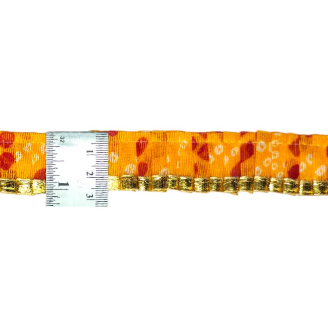 Orange measuring tape with gold accents on a white background