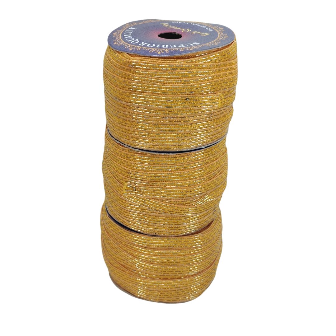 Three spools of gold wire stacked on a white background
